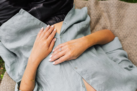 woman lying on back with hands on stomach