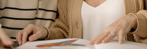 two women reading a book together