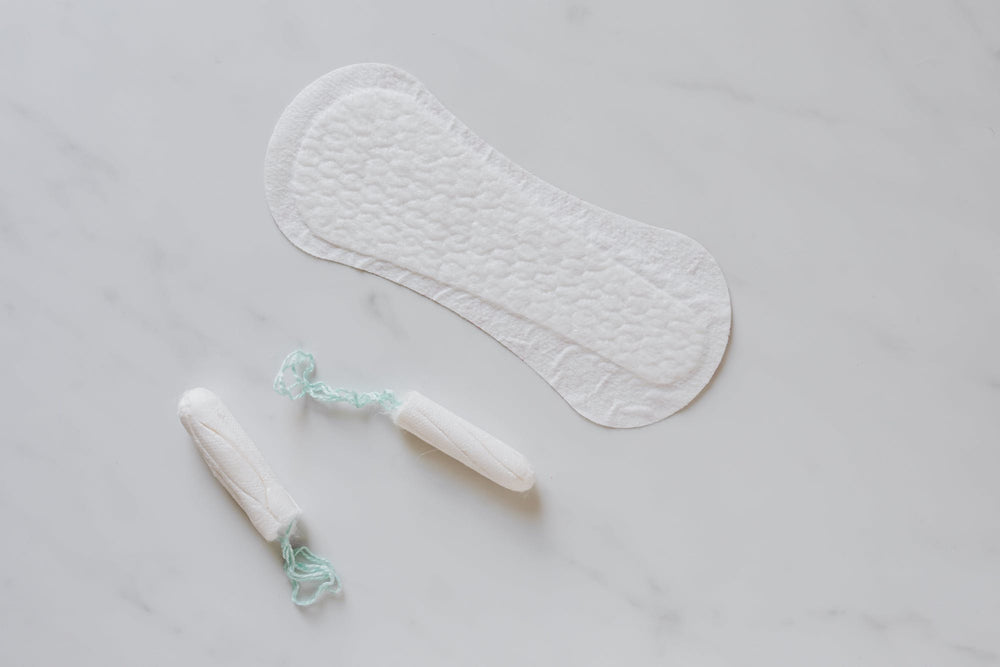 flat lay of menstrual pad and tampon