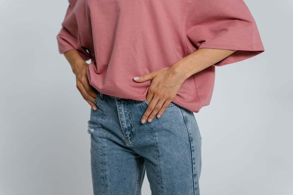 woman in jeans and a t-shirt with her hands partially in her pockets